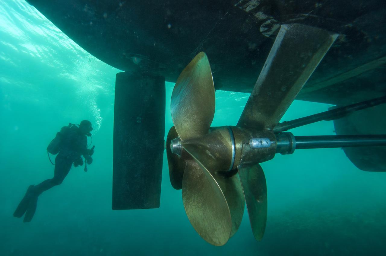 Yacht propeller and running gear underwater with diver